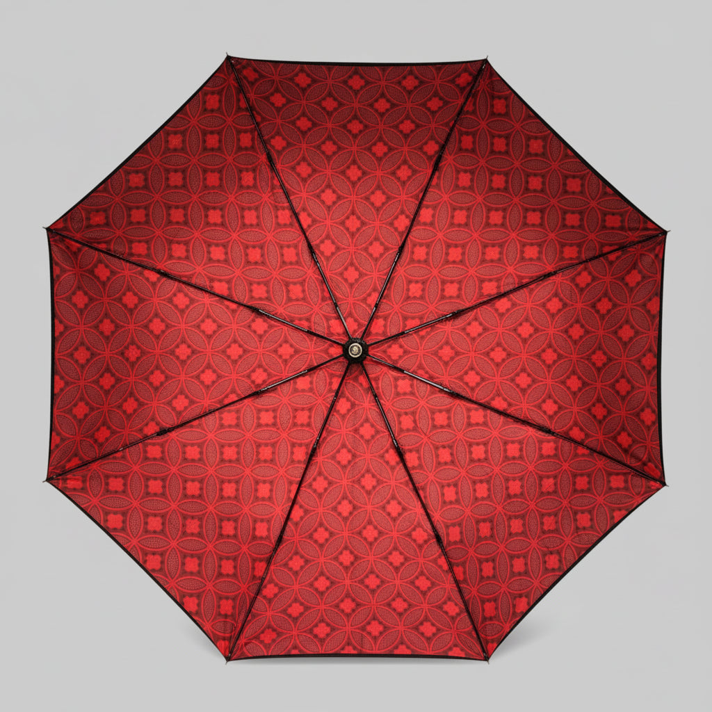 Red patterned umbrella on a light gray background