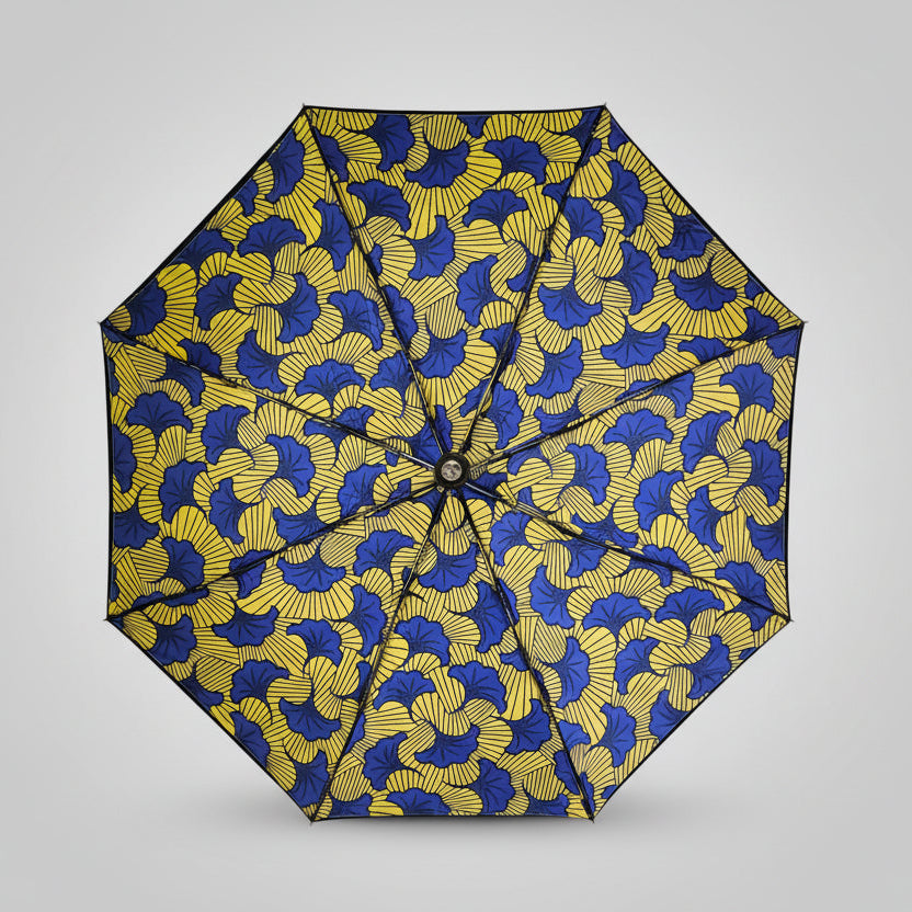 Yellow and blue patterned umbrella on a gray background