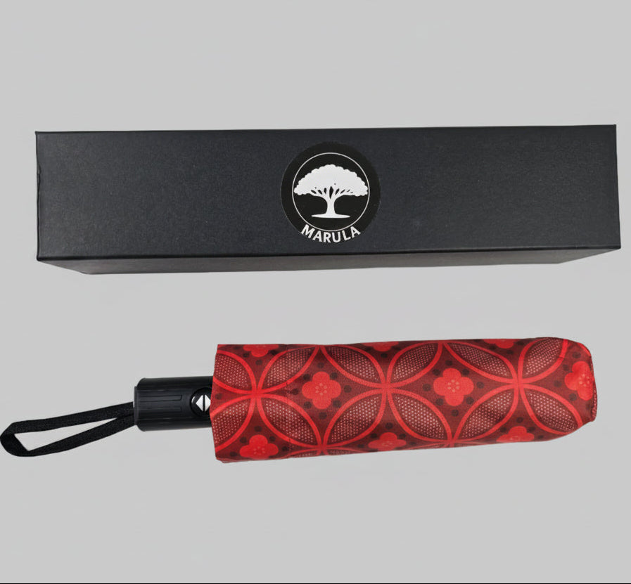 Red patterned umbrella with black handle and Marula logo on packaging