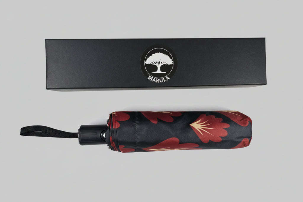 Marula branded umbrella with floral design on a gray background