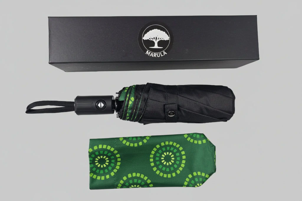 Green patterned umbrella with black handle and Marula logo box on a white background