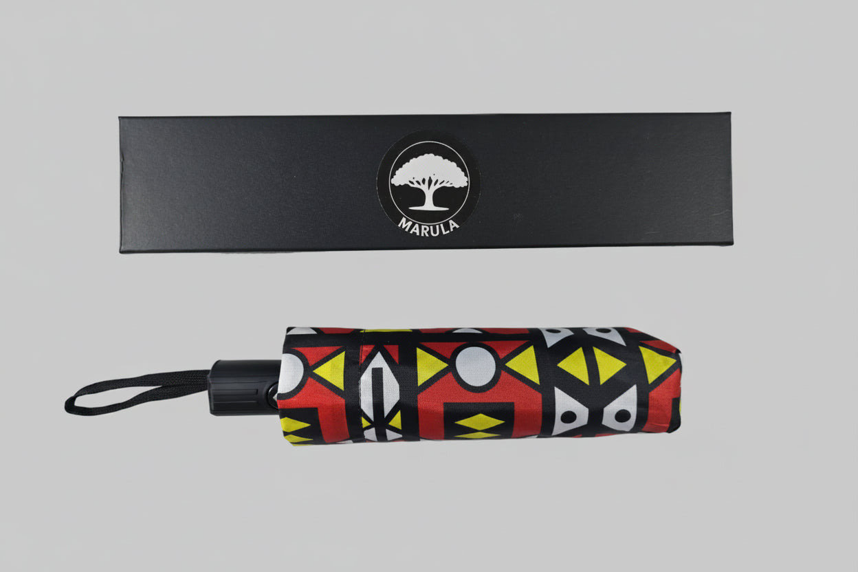 Foldable umbrella with geometric pattern and black box labeled 'Marula' on a white background